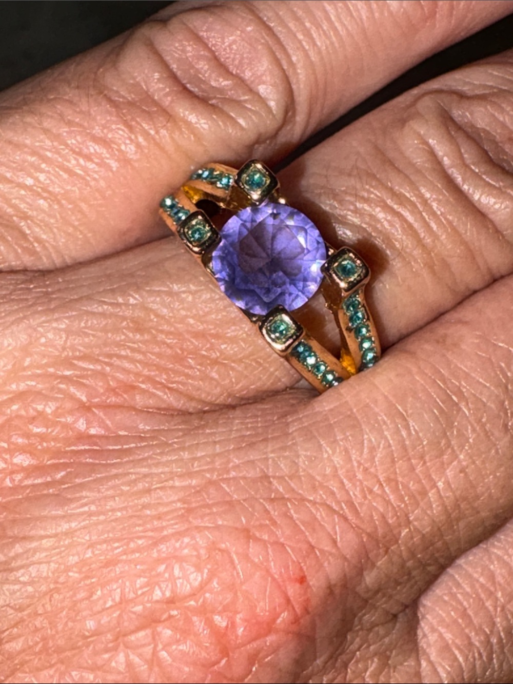 Elegant Gold-Tone Ring with Purple Center Stone and Teal Accents
